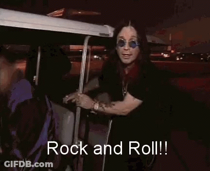 A Man Wearing Sunglasses And A Black Shirt Is Saying Rock And Roll GIF