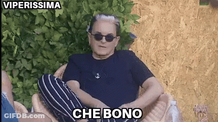 A Man Wearing Sunglasses And A Black Shirt Is Sitting In A Chair With The Words Che Bono Above Him GIF