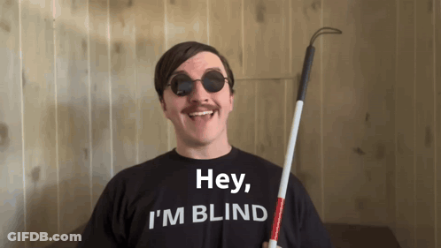 A Man Wearing Sunglasses And A Black Shirt That Says Hey I 'M Blind GIF
