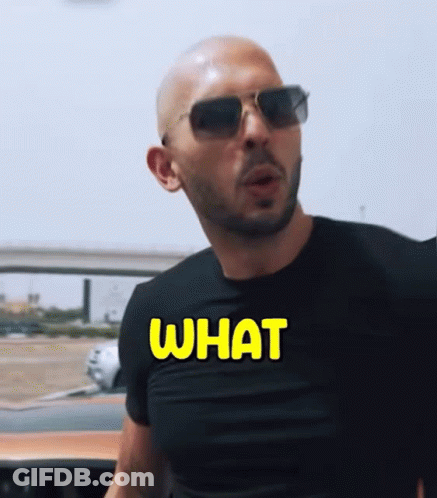 A Man Wearing Sunglasses And A Black Shirt That Says What On It GIF