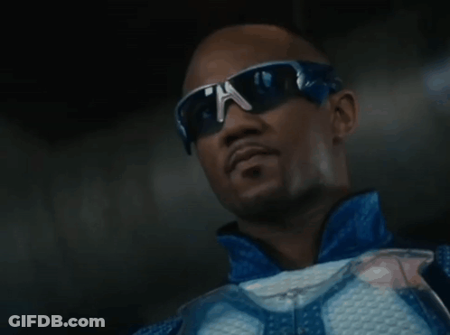 A Man Wearing Sunglasses And A Blue Jacket Is Looking Up GIF
