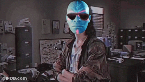 A Man Wearing Sunglasses And A Blue Mask Is Standing In Front Of A Sign That Says Hackerman GIF