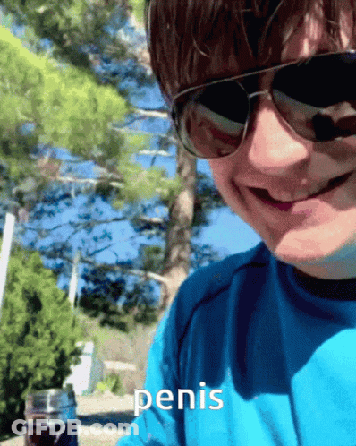 A Man Wearing Sunglasses And A Blue Shirt Has The Word Penis Written On His Shirt GIF