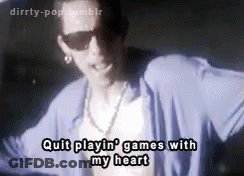 A Man Wearing Sunglasses And A Blue Shirt Is Dancing And Singing . GIF