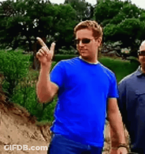 A Man Wearing Sunglasses And A Blue Shirt Is Pointing Up . GIF