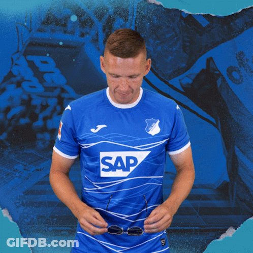 A Man Wearing Sunglasses And A Blue Shirt That Says Sap On It GIF