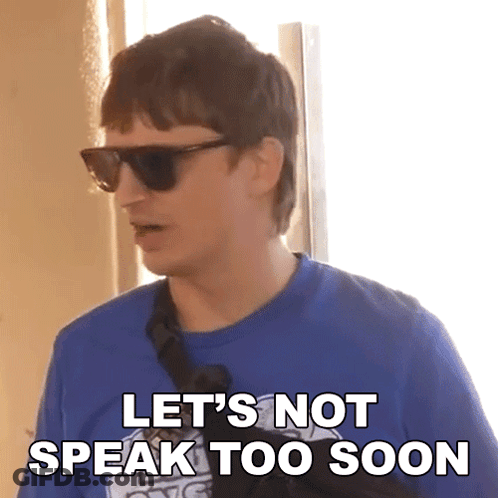 A Man Wearing Sunglasses And A Blue Shirt With The Words Let 'S Not Speak Too Soon GIF