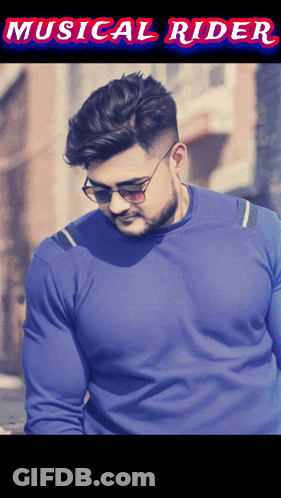 A Man Wearing Sunglasses And A Blue Sweater With The Words Musical Rider On The Bottom GIF