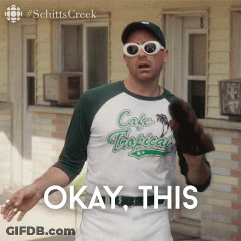 A Man Wearing Sunglasses And A Cafe Tropical Shirt Says " Okay This " GIF