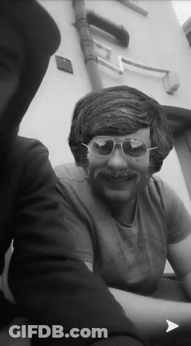 A Man Wearing Sunglasses And A Fake Mustache Is Smiling GIF