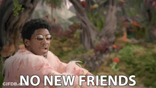A Man Wearing Sunglasses And A Feathered Cape Says " No New Friends " GIF