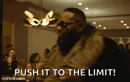 A Man Wearing Sunglasses And A Fur Coat Says Push It To The Limit GIF