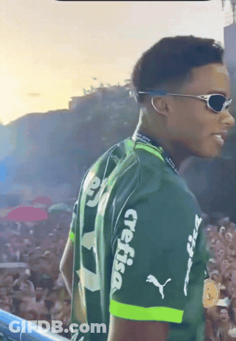 A Man Wearing Sunglasses And A Green Shirt With Crefisa On The Sleeves GIF