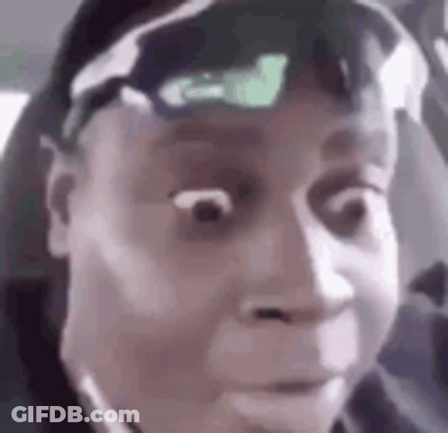 A Man Wearing Sunglasses And A Hat Is Making A Funny Face In A Car . GIF