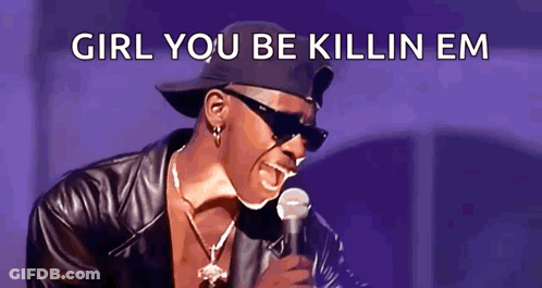A Man Wearing Sunglasses And A Hat Is Singing Into A Microphone With The Words Girl You Be Killin Em Below Him GIF