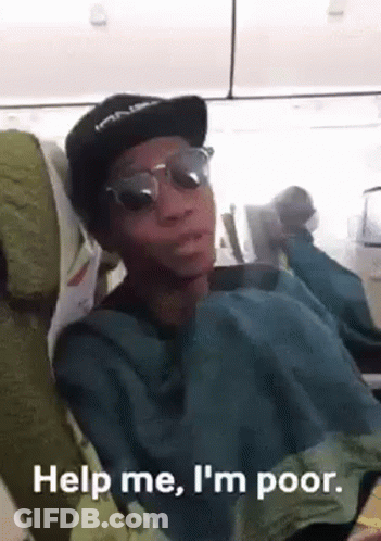 A Man Wearing Sunglasses And A Hat Is Sitting On An Airplane And Making A Funny Face . GIF