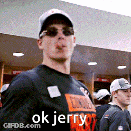 A Man Wearing Sunglasses And A Hat Smoking A Cigarette With The Words Ok Jerry Above Him GIF