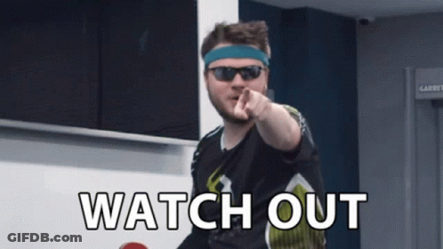 A Man Wearing Sunglasses And A Headband Points At The Camera With The Words Watch Out Written Below Him GIF