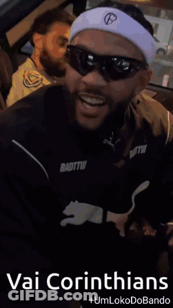 A Man Wearing Sunglasses And A Headband With The Words Vai Corinthians On It GIF