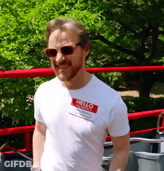 A Man Wearing Sunglasses And A Hello My Name Is Tag On His Shirt GIF