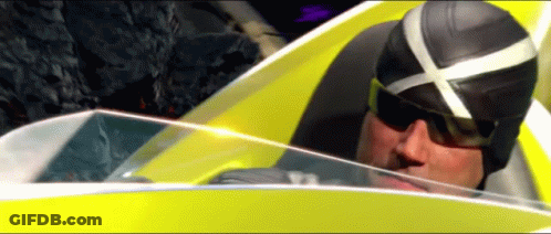 A Man Wearing Sunglasses And A Helmet Is Driving A Yellow Car GIF