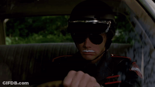 A Man Wearing Sunglasses And A Helmet That Says Amber Island State Police GIF