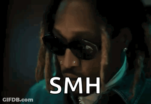 A Man Wearing Sunglasses And A Jacket Is Standing In Front Of A Door With The Word Smh Written On It . GIF