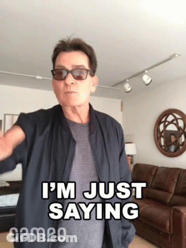 A Man Wearing Sunglasses And A Jacket Says I 'M Just Saying In A Living Room . GIF