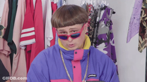 A Man Wearing Sunglasses And A Jacket That Says Patagonia On The Front GIF