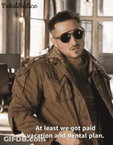 A Man Wearing Sunglasses And A Jacket With The Words At Least We Got Paid Vacation And Dental Plan GIF