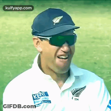 A Man Wearing Sunglasses And A Kent Shirt Smiles For The Camera GIF
