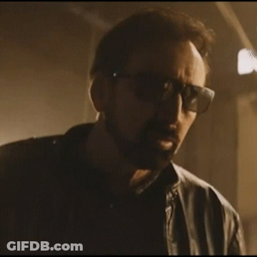 A Man Wearing Sunglasses And A Leather Jacket Is Looking At The Camera GIF