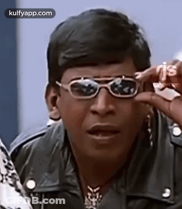 A Man Wearing Sunglasses And A Leather Jacket . GIF
