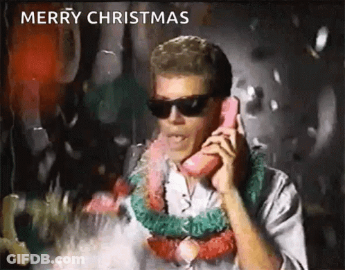 A Man Wearing Sunglasses And A Lei Is Talking On A Pink Telephone . GIF