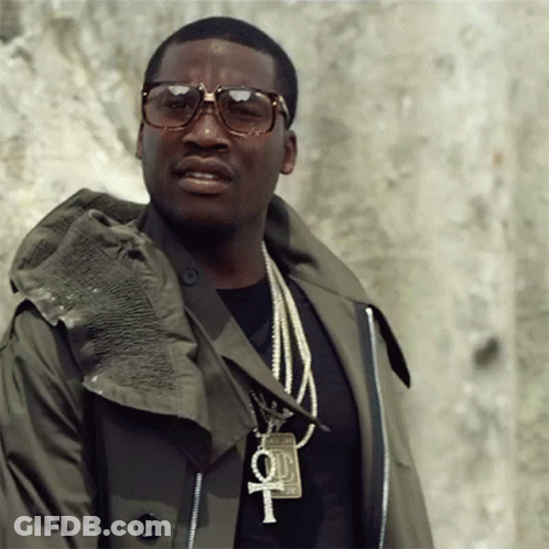 A Man Wearing Sunglasses And A Necklace With A Cross And A 100 Dollar Bill On It GIF
