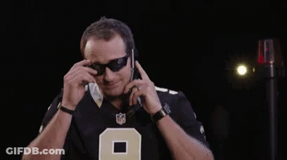 A Man Wearing Sunglasses And A NFL Jersey With The Number 9 On It GIF