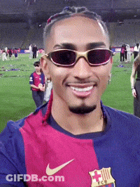 A Man Wearing Sunglasses And A Nike Shirt Is Smiling GIF
