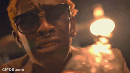 A Man Wearing Sunglasses And A Nose Ring GIF