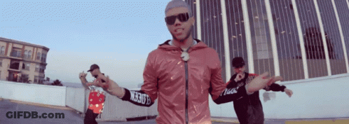 A Man Wearing Sunglasses And A Pink Jacket With A Sleeve That Says ' Ncrb ' On It GIF