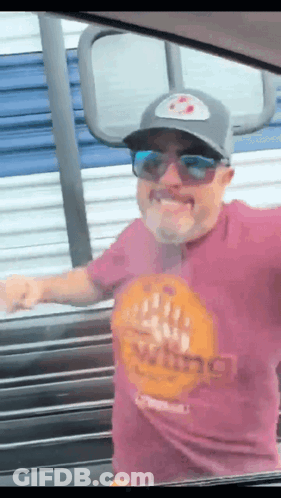 A Man Wearing Sunglasses And A Purple Shirt That Says Viking GIF