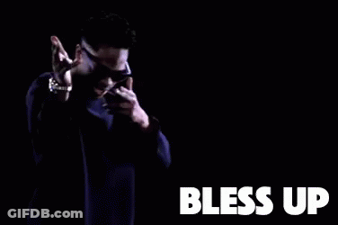 A Man Wearing Sunglasses And A Purple Sweater Is Dancing In A Dark Room With The Words Bless Up . GIF