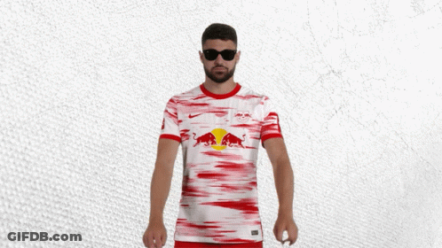 A Man Wearing Sunglasses And A Red And White Shirt With A Red Bull On It GIF