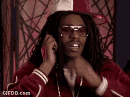 A Man Wearing Sunglasses And A Red Jacket Is Talking On A Cell Phone With The Word Hhh Above Him GIF