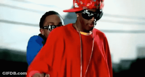A Man Wearing Sunglasses And A Red Shirt Has The Letter R On His Shirt GIF