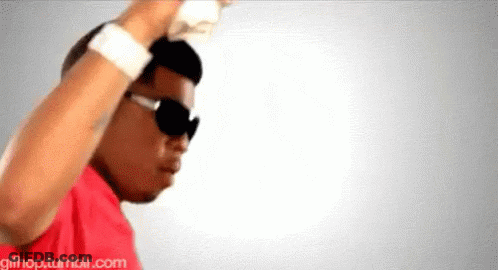 A Man Wearing Sunglasses And A Red Shirt Is Dancing In Front Of A White Background .. GIF