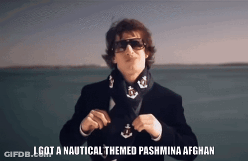 A Man Wearing Sunglasses And A Scarf Has The Words I Got A Nautical Themed Pashmina Afghan On The Bottom GIF
