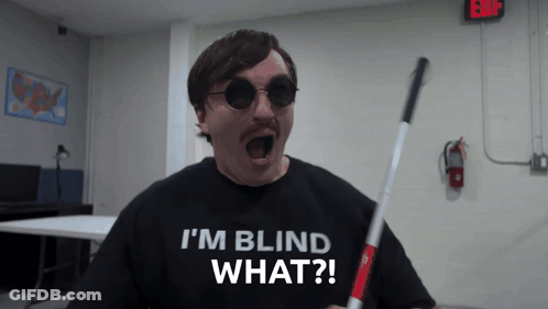 A Man Wearing Sunglasses And A Shirt That Says " I 'M Blind What " GIF