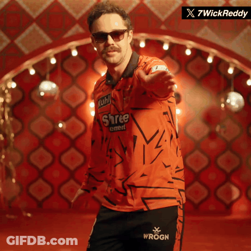 A Man Wearing Sunglasses And A Shree Cement Shirt GIF