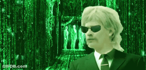 A Man Wearing Sunglasses And A Suit And Tie Is Standing In Front Of A Green Background . GIF