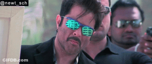 A Man Wearing Sunglasses And A Suit Has The Name Newt Sch On The Bottom GIF
